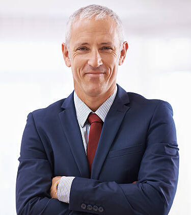Cropped shot of a mature businessman with folded arms Cropped shot of a mature businessman with folded arms